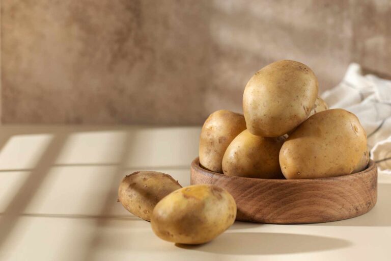 Raw potatoes in a bowl. The concept of harvesting, organic food. Copy space